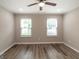 A bedroom features hardwood-style floors, a ceiling fan, and painted in light neutral shade at 1017 Ridgefield Dr, Peachtree City, GA 30269