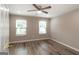 Bedroom has hardwood-style floors, neutral colors, and ceiling fan at 1017 Ridgefield Dr, Peachtree City, GA 30269