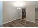Bright dining room with hardwood floors, neutral walls, and modern lighting fixtures at 1017 Ridgefield Dr, Peachtree City, GA 30269