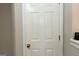 An interior white paneled door with brushed gold hardware at 1017 Ridgefield Dr, Peachtree City, GA 30269