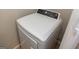 A modern, white Frigidaire dryer unit is featured in a compact laundry area at 1017 Ridgefield Dr, Peachtree City, GA 30269