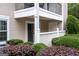 Ground floor patio of a condo with neat, surrounding greenery and picket fence at 1017 Ridgefield Dr, Peachtree City, GA 30269