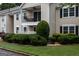 View of a well-maintained condo showcasing its balcony and lush landscaping at 1017 Ridgefield Dr, Peachtree City, GA 30269
