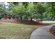 A serene outdoor landscape featuring a walking path and mature trees with recreational area at 1017 Ridgefield Dr, Peachtree City, GA 30269