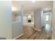 Hallway with modern gray walls and hardwood flooring leading to a living room at 1017 Ridgefield Dr, Peachtree City, GA 30269