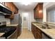 Updated kitchen with granite counters, stainless appliances, and warm wood cabinetry at 1017 Ridgefield Dr, Peachtree City, GA 30269