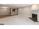 Open-concept living area with carpet, wood flooring, and fireplace at 1017 Ridgefield Dr, Peachtree City, GA 30269