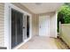 Covered patio features sliding glass doors, a storage closet, and privacy wall with greenery at 1017 Ridgefield Dr, Peachtree City, GA 30269