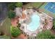 Aerial view of a community pool with tables, chairs, and umbrellas for residents at 1017 Ridgefield Dr, Peachtree City, GA 30269