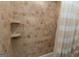 A close up of a tiled shower/tub with built-in shelves at 1017 Ridgefield Dr, Peachtree City, GA 30269