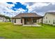 Home backyard featuring a covered patio and green grass at 209 Cottonwood Cir, Peachtree City, GA 30269