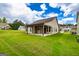 Backyard of home featuring covered patio and green grass at 209 Cottonwood Cir, Peachtree City, GA 30269