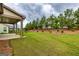 Expansive backyard with lush green grass, complemented by mature trees and landscaping at 209 Cottonwood Cir, Peachtree City, GA 30269
