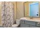 Well-lit bathroom with modern vanity and shower with marble-patterned curtain at 209 Cottonwood Cir, Peachtree City, GA 30269