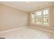 Bright, empty room with tile floors, neutral paint, and large windows letting in natural light at 209 Cottonwood Cir, Peachtree City, GA 30269