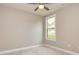 Cozy bedroom featuring neutral walls, carpet floors, and a bright window at 209 Cottonwood Cir, Peachtree City, GA 30269