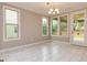 Dining area featuring modern lighting, large windows, and an adjacent exterior door at 209 Cottonwood Cir, Peachtree City, GA 30269