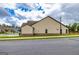 Clean single-Gathering home featuring a well-kept lawn, simple landscaping, and a practical three-car garage at 209 Cottonwood Cir, Peachtree City, GA 30269