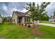 Inviting single-Gathering home showcasing a well-kept lawn, decorative shrubs, and a practical three-car garage at 209 Cottonwood Cir, Peachtree City, GA 30269