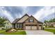 Charming single-Gathering home with stone accents, manicured lawn, and a spacious three-car garage at 209 Cottonwood Cir, Peachtree City, GA 30269