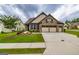 Well-maintained single-Gathering home featuring a lush lawn, tidy landscaping, and a convenient three-car garage at 209 Cottonwood Cir, Peachtree City, GA 30269