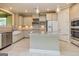 Bright kitchen featuring stainless steel appliances, granite counters, and white cabinets at 209 Cottonwood Cir, Peachtree City, GA 30269