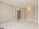 Open living space with white tile floors and French doors leading to another room at 209 Cottonwood Cir, Peachtree City, GA 30269