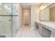 Main bathroom featuring a glass enclosed shower, walk-in closet, and marble topped vanity at 209 Cottonwood Cir, Peachtree City, GA 30269