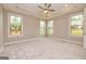 Spacious main bedroom with large windows, recessed lighting, and ceiling fan at 209 Cottonwood Cir, Peachtree City, GA 30269