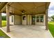 Inviting covered patio featuring a ceiling fan and ample space for outdoor entertaining at 209 Cottonwood Cir, Peachtree City, GA 30269