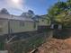 Home's backyard area with chain link fence and partial patio is ready for your creative touch at 7290 Grayson Dr, Riverdale, GA 30296