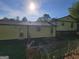Home's backyard featuring a partial patio and mature tree coverage at 7290 Grayson Dr, Riverdale, GA 30296