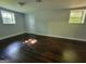 Finished basement featuring hardwood floors, two windows, and neutral paint tones at 7290 Grayson Dr, Riverdale, GA 30296