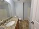 Clean bathroom featuring a vanity with granite countertops, modern fixtures, and a shower/tub combo at 7290 Grayson Dr, Riverdale, GA 30296