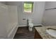 Bathroom with a vanity, granite countertops, updated fixtures, shower/tub combo, and neutral color palette at 7290 Grayson Dr, Riverdale, GA 30296