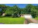Charming home with brick and white siding, a garage, and a green lawn at 7290 Grayson Dr, Riverdale, GA 30296