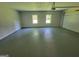 Spacious garage with windows, painted floors, and an automatic garage door opener at 7290 Grayson Dr, Riverdale, GA 30296