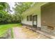 Back patio area with white siding and brick corner and an exterior door leading to the backyard at 1350 Lori Ct, Conley, GA 30288
