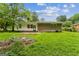 Exterior view of backyard and the back of the house in a green lawn setting at 1350 Lori Ct, Conley, GA 30288