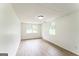 Spacious room with white walls, a drop ceiling, and wood grain flooring at 1350 Lori Ct, Conley, GA 30288