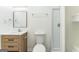 Bright bathroom featuring a wood vanity, framed mirror, and shower stall at 1350 Lori Ct, Conley, GA 30288