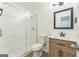 Modern bathroom with marble shower, wooden vanity and framed mirror at 1350 Lori Ct, Conley, GA 30288