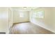 Well-lit room with light, sleek wood flooring and natural light from windows at 1350 Lori Ct, Conley, GA 30288