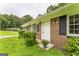 Charming single-story brick home with manicured landscaping, front door, and black shuttered windows at 1350 Lori Ct, Conley, GA 30288