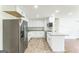 Modern kitchen featuring stainless steel appliances, white cabinets, granite counters, and tile flooring for a sleek design at 1350 Lori Ct, Conley, GA 30288