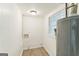 Compact laundry room featuring white walls, vinyl flooring and a water heater at 1350 Lori Ct, Conley, GA 30288