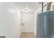 Compact laundry room featuring white walls, vinyl flooring and a water heater at 1350 Lori Ct, Conley, GA 30288