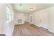 Spacious living room with a decorative brick fireplace, new floors, and ample natural light from large windows at 1350 Lori Ct, Conley, GA 30288