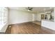 Open-concept living space with hardwood floors flowing into an updated kitchen with stainless steel appliances and granite countertops at 1350 Lori Ct, Conley, GA 30288