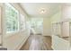 Sun-drenched sunroom featuring vinyl flooring, large windows offering serene outdoor views, and crisp white trim at 1350 Lori Ct, Conley, GA 30288